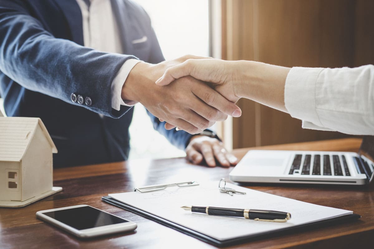 Customer shaking hands with escrow agent